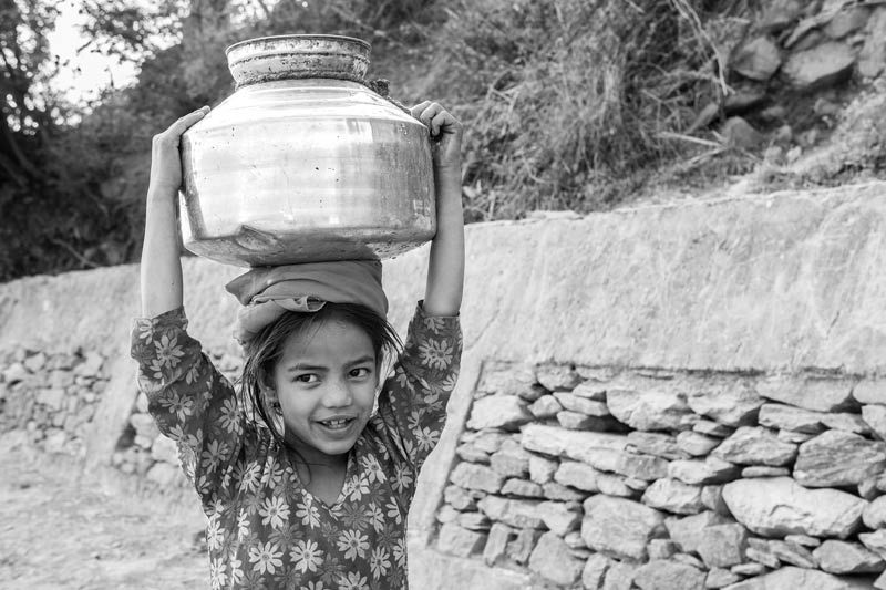 Water portraits - A village girl carrying water from a distant roadside handpump – near Tehri, Uttarakhand